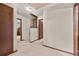 Hallway featuring white carpet, wallpapered walls, wooden trim, and access to various rooms at 837 Pine Ridge Dr, Lawrenceville, GA 30043