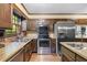 Traditional kitchen with stainless steel appliances, brick accents, and wood cabinetry at 837 Pine Ridge Dr, Lawrenceville, GA 30043