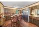 Eat-in kitchen offers dark wood cabinetry and brick backsplash at 837 Pine Ridge Dr, Lawrenceville, GA 30043
