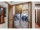 Convenient laundry closet featuring a washer and dryer, with vintage cabinet at 837 Pine Ridge Dr, Lawrenceville, GA 30043