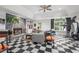 Unique living space with a stone fireplace, black and white floors, and exercise equipment at 837 Pine Ridge Dr, Lawrenceville, GA 30043