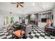 Inviting living space with stone fireplace, built-in shelves, checkerboard floor, and access to the back patio at 837 Pine Ridge Dr, Lawrenceville, GA 30043