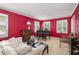 Cozy living room with bright red walls, large windows, and comfortable seating at 837 Pine Ridge Dr, Lawrenceville, GA 30043