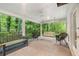 Relaxing covered patio with seating, fan, and a porch swing overlooking a beautiful green landscape at 837 Pine Ridge Dr, Lawrenceville, GA 30043