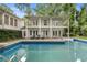 Backyard pool featuring clear blue water, diving board, and multi-story home with balconies at 837 Pine Ridge Dr, Lawrenceville, GA 30043