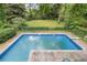 Backyard view featuring a large in-ground pool surrounded by well-maintained landscaping at 837 Pine Ridge Dr, Lawrenceville, GA 30043