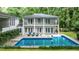 Backyard view of a beautiful in-ground pool and deck area with lounge chairs at 837 Pine Ridge Dr, Lawrenceville, GA 30043