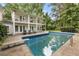 Backyard pool featuring clear blue water, diving board, and a multi-story home in the background at 837 Pine Ridge Dr, Lawrenceville, GA 30043