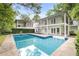 Swimming pool area with greenery and a two-story home at 837 Pine Ridge Dr, Lawrenceville, GA 30043