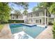 Backyard pool featuring clear blue water, a multi-story home, and lush landscaping at 837 Pine Ridge Dr, Lawrenceville, GA 30043