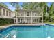 Backyard featuring a two-story home, pool, and lounge chairs at 837 Pine Ridge Dr, Lawrenceville, GA 30043
