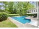 Beautiful pool area with a grassy lawn, a lounge chair, and greenery at 837 Pine Ridge Dr, Lawrenceville, GA 30043