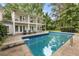 Swimming pool with diving board and ladder in backyard with lush trees at 837 Pine Ridge Dr, Lawrenceville, GA 30043