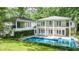 Large swimming pool in a backyard, with a view of the house and surrounding greenery at 837 Pine Ridge Dr, Lawrenceville, GA 30043