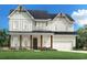 Charming two-story home featuring a welcoming front porch, white siding, and a well-manicured lawn at 4710 Crestline View Rd, Cumming, GA 30028