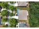 Aerial view of a home featuring a brown roof, large backyard, and a paved driveway at 9117 Hanover St, Lithia Springs, GA 30122