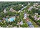 The aerial view captures the layout of a residential neighborhood with a pool and mature trees at 9117 Hanover St, Lithia Springs, GA 30122