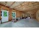 Unfinished basement with exposed wood framing, a white door, and large windows at 9117 Hanover St, Lithia Springs, GA 30122