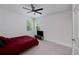 Neutral bedroom with carpeting, ceiling fan, and a TV on a console at 9117 Hanover St, Lithia Springs, GA 30122