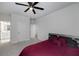 Relaxing bedroom with gray walls, ceiling fan and adjoining bathroom at 9117 Hanover St, Lithia Springs, GA 30122
