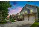 Attractive two-story home featuring stone accents, a front porch, and an expansive driveway during twilight at 9117 Hanover St, Lithia Springs, GA 30122