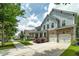 Two-story home with a two-car garage, stone accents, and a manicured front lawn at 9117 Hanover St, Lithia Springs, GA 30122