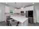 Well-lit kitchen with white cabinets, stainless appliances, and quartz countertops at 9117 Hanover St, Lithia Springs, GA 30122