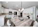 Spacious kitchen featuring white cabinets, stainless appliances, and a large dining table at 9117 Hanover St, Lithia Springs, GA 30122