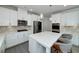Bright kitchen with white cabinets, stainless appliances, and quartz countertops at 9117 Hanover St, Lithia Springs, GA 30122