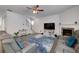 Open living room with gray couches, fireplace, and stairs to the second level at 9117 Hanover St, Lithia Springs, GA 30122