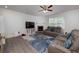 Spacious living room features a fireplace, comfortable seating, and a modern ceiling fan at 9117 Hanover St, Lithia Springs, GA 30122