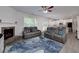 Bright living room features gray sofas, a fireplace, and an open view to the kitchen at 9117 Hanover St, Lithia Springs, GA 30122