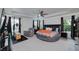 Expansive main bedroom featuring a tray ceiling, ceiling fan, and windows at 9117 Hanover St, Lithia Springs, GA 30122