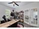 Well-lit home office with a spacious desk, a bookshelf, and charming french doors at 9117 Hanover St, Lithia Springs, GA 30122