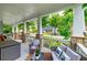 Inviting front porch with comfortable seating, stone pillars, and a view of the neighborhood at 9117 Hanover St, Lithia Springs, GA 30122