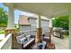 Relaxing covered back porch with a grill, comfortable seating, and scenic views of the backyard at 9117 Hanover St, Lithia Springs, GA 30122