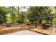 Backyard patio with outdoor dining table amidst lush landscaping at 1236 S Shadygrove Ct, Stone Mountain, GA 30083