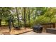 Backyard patio area features an outdoor dining table and barbecue at 1236 S Shadygrove Ct, Stone Mountain, GA 30083