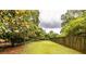 Grassy backyard area with beautiful magnolia trees and landscaping at 1236 S Shadygrove Ct, Stone Mountain, GA 30083