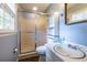 Bathroom featuring a stand up shower with glass doors, vanity sink with storage, and updated fixtures at 1236 S Shadygrove Ct, Stone Mountain, GA 30083