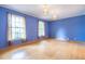 Bright, spacious bedroom with beautiful hardwood floors, blue walls, and ample natural light at 1236 S Shadygrove Ct, Stone Mountain, GA 30083