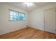 A bedroom with hardwood floors, window, and a door at 1236 S Shadygrove Ct, Stone Mountain, GA 30083