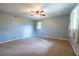 Spacious bedroom features a ceiling fan and natural light from two windows at 1236 S Shadygrove Ct, Stone Mountain, GA 30083