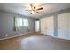 Bedroom with large closet, neutral color palette, and carpet flooring at 1236 S Shadygrove Ct, Stone Mountain, GA 30083