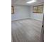 Well-lit bedroom with wood-look floors, neutral paint, and large windows, perfect for relaxation and comfort at 1236 S Shadygrove Ct, Stone Mountain, GA 30083
