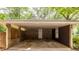 View of the brick carport featuring a door leading into the house and an adjacent window, offering convenient covered parking at 1236 S Shadygrove Ct, Stone Mountain, GA 30083