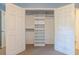 Open double-door closet with built-in shelving and hanging rods at 1236 S Shadygrove Ct, Stone Mountain, GA 30083