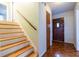 Inviting entryway features hardwood floors, stairs with wooden railing, and a solid wood door at 1236 S Shadygrove Ct, Stone Mountain, GA 30083
