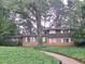 Charming two-story brick home with mature trees and lush ground cover in a tranquil setting at 1236 S Shadygrove Ct, Stone Mountain, GA 30083