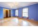 Hardwood floors, blue walls, pendant lighting, and entryways define this inviting living space at 1236 S Shadygrove Ct, Stone Mountain, GA 30083